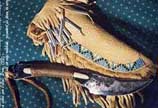 Bone handle with binding wire, there is a peyote stitch beadwork on the knife lace, not show on the picture. rawhide sheath covered with beaded buckskin.(10/0 beads)