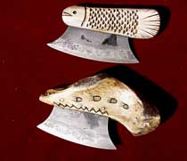 67/ Two ulu, Inuit knives, exclusively used by women for cooking and skinning. one in bone, the other is a carved rein-deer. made from real antics pieces.